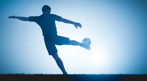 Football soccer player shooting a ball on goal. Perfect shot