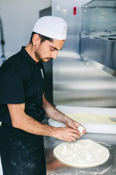 Italian Chef Pizzaiolo Putting Mozzarella Cheese Pizza Restaurant Kitchen — Stock Photo, Image
