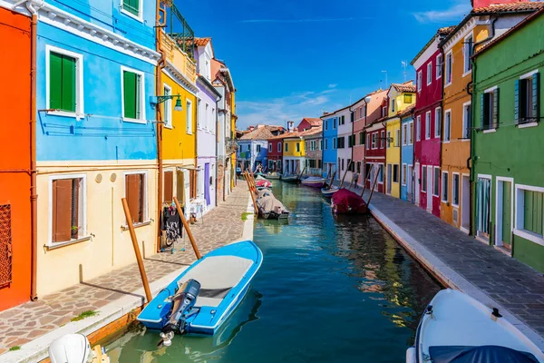 stock image Burano, Italy with colorful painted houses along canal with boats. Scenic Italian town near Venice