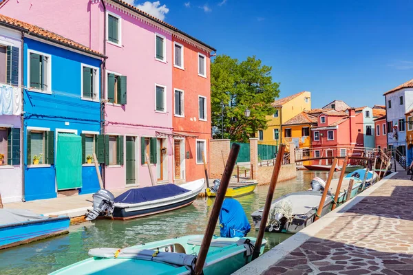 stock image Burano, Italy with colorful painted houses along canal with boats. Scenic Italian town near Venice