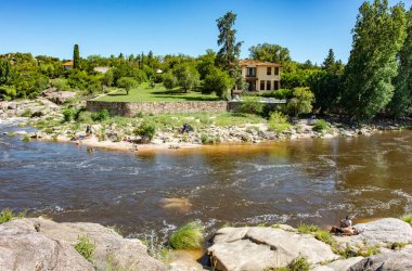 Mina Clavero, Cordoba Argentina 01.01.2023: Extraordinary nature of the province of Cordoba Argentina in the city of Mina Clavero and people resting on the river