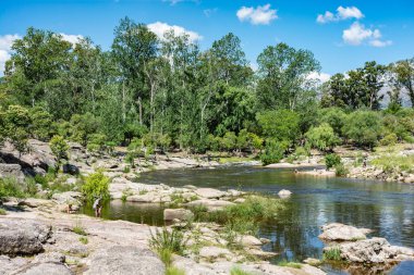 Mina Clavero, Cordoba Argentina 01.01.2023: Extraordinary nature of the province of Cordoba Argentina in the city of Mina Clavero and people resting on the river
