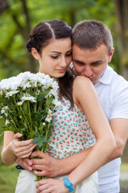 Happy young couple in love outdoors in park