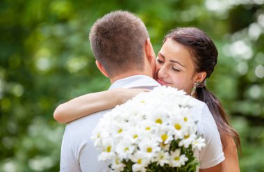 Happy young couple in love outdoors in park
