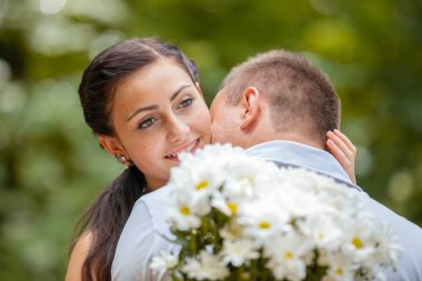 Happy young couple in love outdoors in park