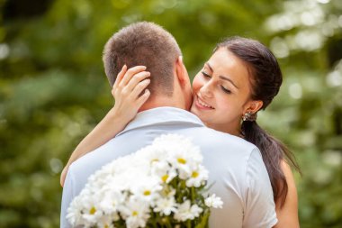 Happy young couple in love outdoors in park