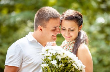Happy young couple in love outdoors in park