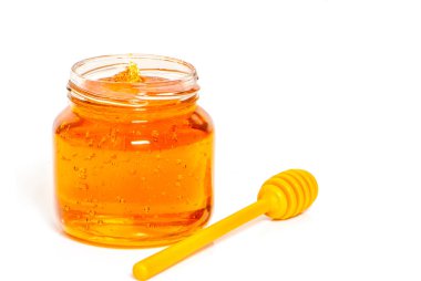 beyaz zemin üzerine bal ile jar