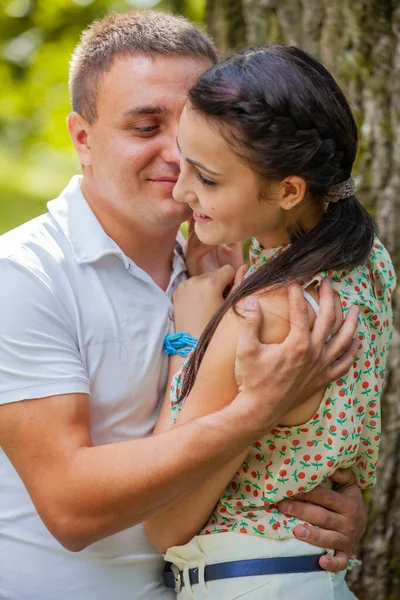 Happy young couple in love outdoors in park