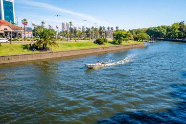 Tigre, Argentina - February 21, 2023: resting people in boats on the river in the city of Tigris