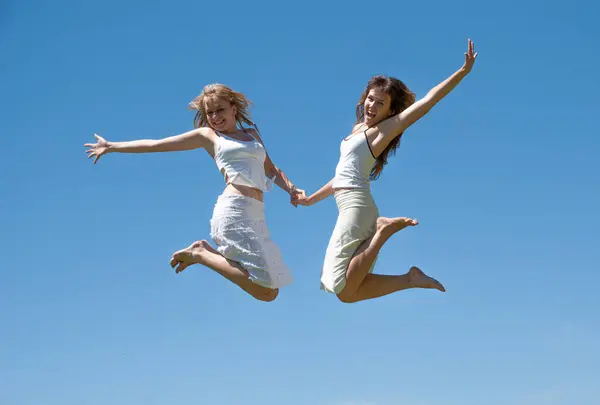 Happy Girls Jumping Sky Stock Photo