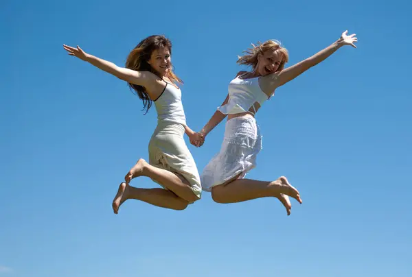 Happy Girls Jumping Sky Royalty Free Stock Images