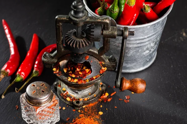 Mill Finely Ground Red Hot Pepper Pepper Pods Black Table — Stock Photo, Image