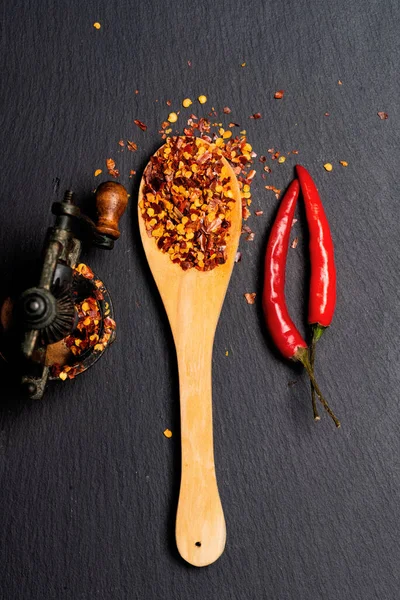 Ground Red Pepper Wood Spoon Fresh Pepper Pods Black Stone — Stock Photo, Image