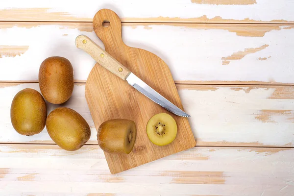 Kiwi Gesneden Hele Vruchten Snijplank Met Mes Witte Tafel Kopieerruimte — Stockfoto