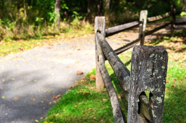 Ormandaki köy yolunun kenarındaki eski ahşap çit. Yakın plan, seçici odaklanma. Metin için boşluk.