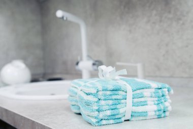 Mutfak havluları mutfak masasının üzerine istiflenmiş lavabo ve musluğun yanına. Metin için boşluk.