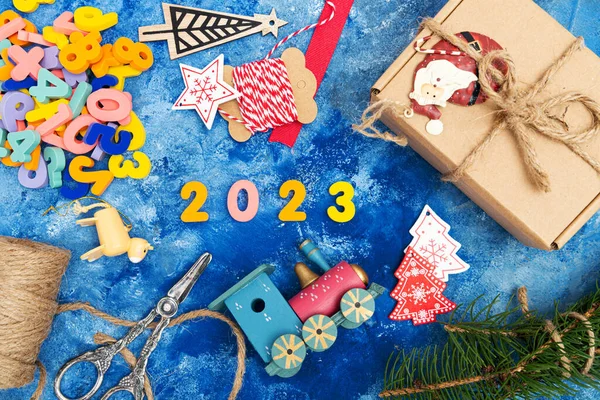 新年作文 编号2023 圣诞装饰品 冷杉枝条 蓝色背景的球果 从上面看 — 图库照片