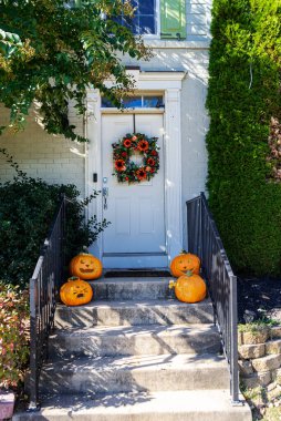 Cadılar Bayramı süslemeli ön kapı çeşitli boyutlarda ve şekilli balkabaklarıyla