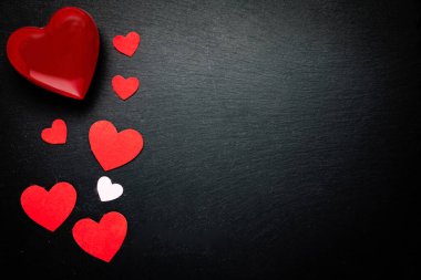 red hearts on black background. valentine's day background. Space for text. top view.