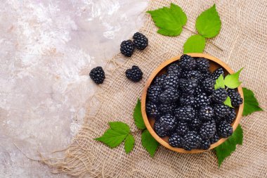 fresh blackberries in a wooden plate. View from above.Copy space.