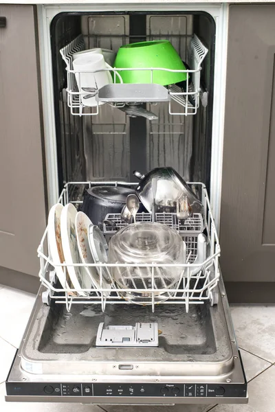 open dishwasher with dirty dishes. Loading the dishwasher.
