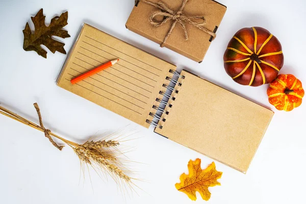 Autumn composition: fallen leaves and a notepad. space for text. View from above. Flat lay with copy space.