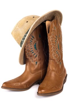 Leather cowgirl boots with embroidery and hat isolated on white background.