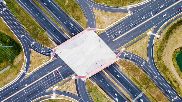 From above, aerial view of a new interchange in the city of Leesburg, Virginia. Modern building design of the roadway to avoid traffic jams. Few cars.