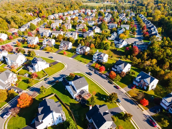 suburb, view from above. Autumn landscape with colorful trees. Real estate, residential buildings of one-story America.