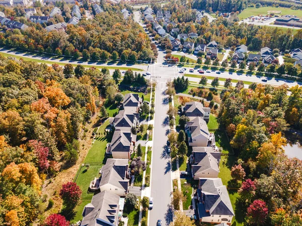 low-rise residential neighborhoods in Virginia. View from above. Residential single-family houses with parking lots and parks. Autumn landscape.