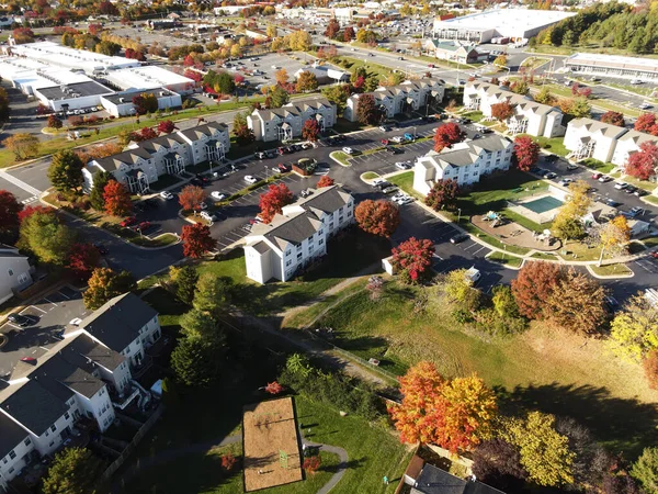 suburb, view from above. Autumn landscape with colorful trees. Real estate, residential buildings of one-story America.