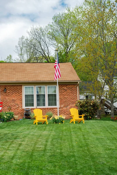 stock image Patriotic yard at home. Neat lawn with American flag and chairs. Decoration for independence day.