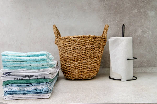 folded towels and a wicker laundry basket on the kitchen table. copy space.