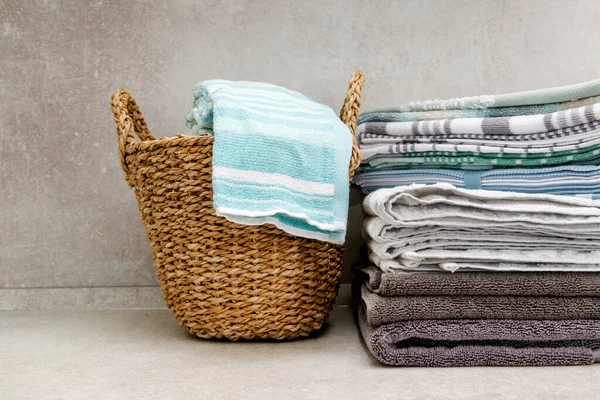 folded towels and  wicker laundry basket on the kitchen table. copy space.
