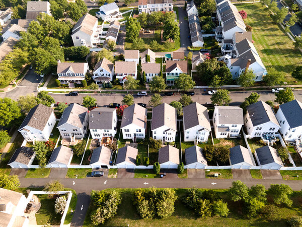 Aerial view of a neighborhood of low-rise buildings on a summer day. Single-family homes from a bird's eye view.