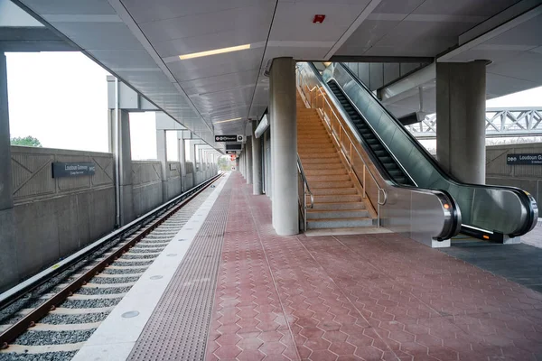 Washington Metro. New underground station in Ashbourn. Railway tracks and escalators.