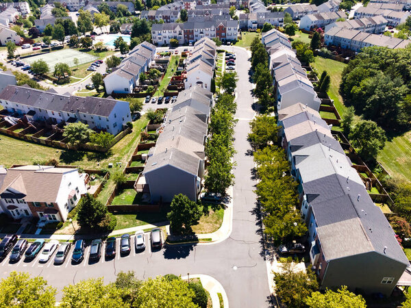 Streets and residential buildings in an urban neighborhood. Parking, tennis court and swimming pool. Top view of the American community.
