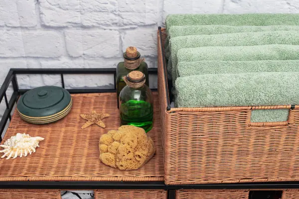 bath towels on a wicker nightstand. Rattan furniture and towels in the bathroom