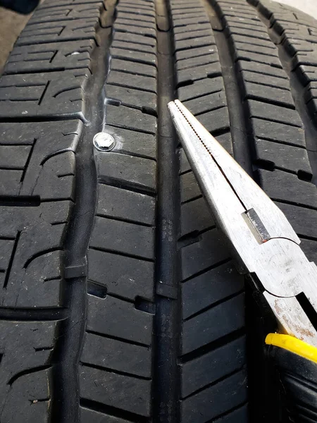 Beschädigter Zerstochener Reifen Nahaufnahme Eines Nagels Lauffläche Und Zange — Stockfoto