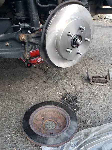 Old and new brake disc of the car brake system.