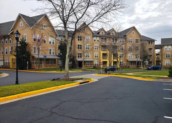 Stock image row of residential townhomes. Concept of real estate development, the housing market, and homeownership.