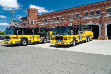 fire station with yellow fire trucks in the city of Ashburn in Virginia. clipart