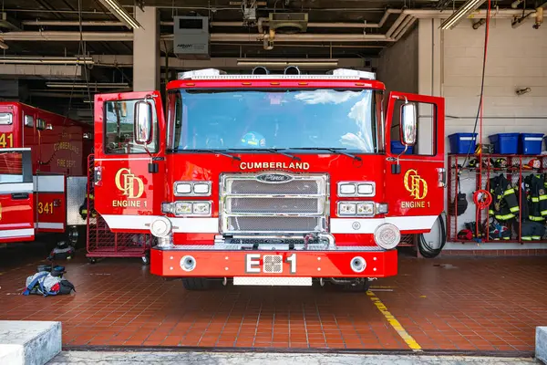 stock image city fire station - doors open and trucks in ready mode.