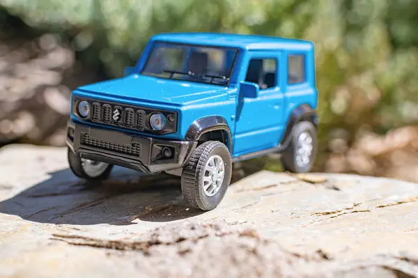 stock image Blue Japanese SUV Suzuki Jimny in the mountains. A car for tourism and extreme adventures.