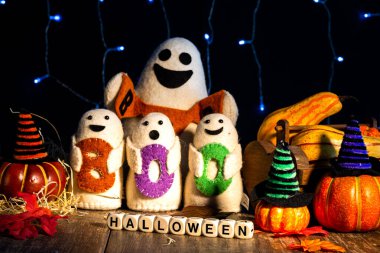 cheerful family of ghost dolls with the word Boo and pumpkins ready for Halloween clipart