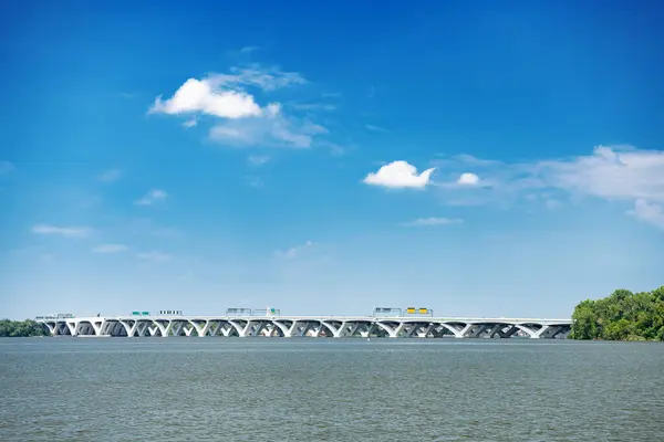 stock image Long Bridge over the Bay. Blue sky with clouds.