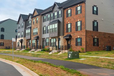 Şehirdeki üç katlı apartman, düşük enerji standartlarına sahip yeni modern konutların cephesi. Tuğla cephesi bitti.