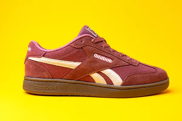 stock image Reebok sports shoes for running and walking. Sneakers made of suede on a yellow background.