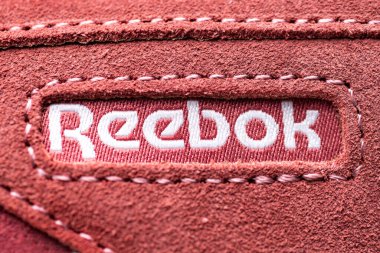 Süet spor ayakkabılarına yakın plan Reebok logosu.